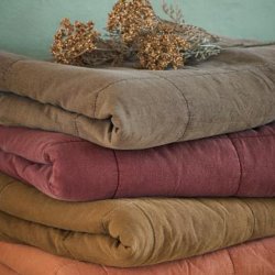 Vintage quilts fra Ib Laursen i Sienna, Truffle, Dusty Plum og Ochre Green stablet p� tr�bord